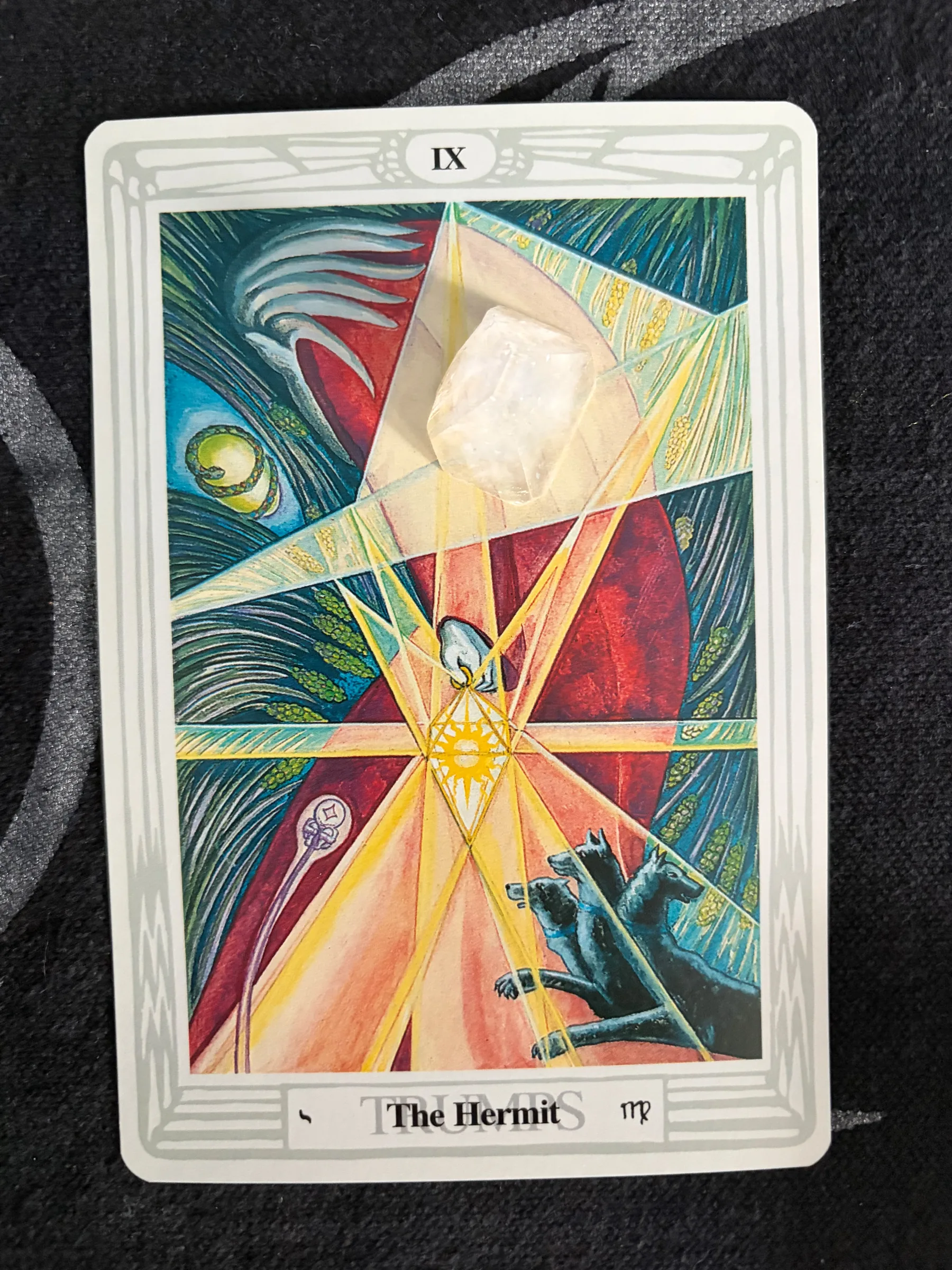 Tarot card illustration of The Hermit with a glowing diamond lantern.